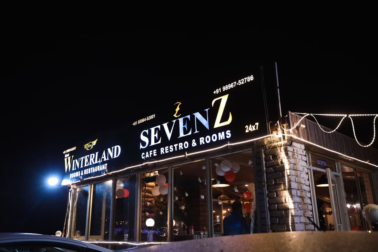 Illuminated SevenZ sign at night