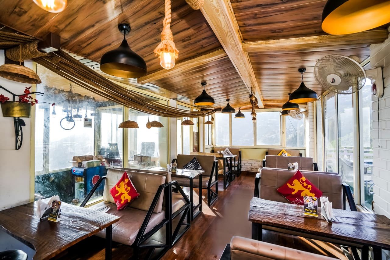 Cedar-panelled cafe interior with low pendant lamps