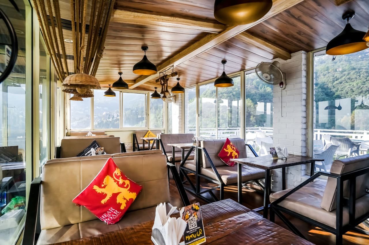 Dining tables beside floor-to-ceiling glass
